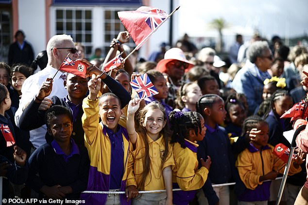 People wait for the arrival of King Charles III at King's Square in St George's, Bermuda, today