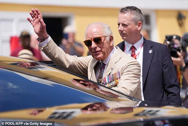 The King waves at onlookers in Bermuda