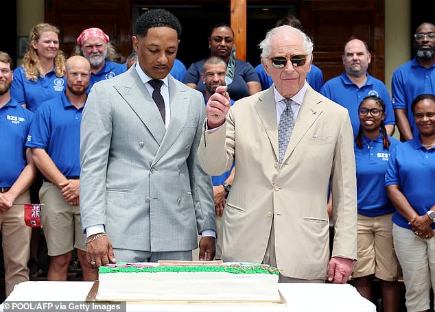 King Charles III with Bermuda's MP Jache Adams cuts a cake to mark the centenary of the Bermuda Aquarium Museum during his first visit to the Overseas Territory