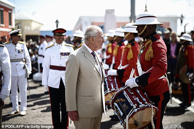 Charles greets a member of the Royal Bermuda Regiment Band and Corps of Drums today