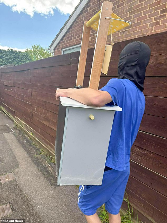 Pictured: One of the balaclava-clad youths who stole Maisie's egg stand
