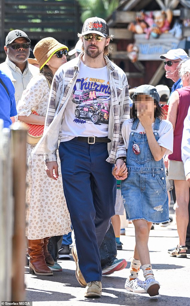 Gosling, 45, was a doting dad as he held his daughter's hands as they strolled through Disneyland, while Mendes, 52, trailed behind them