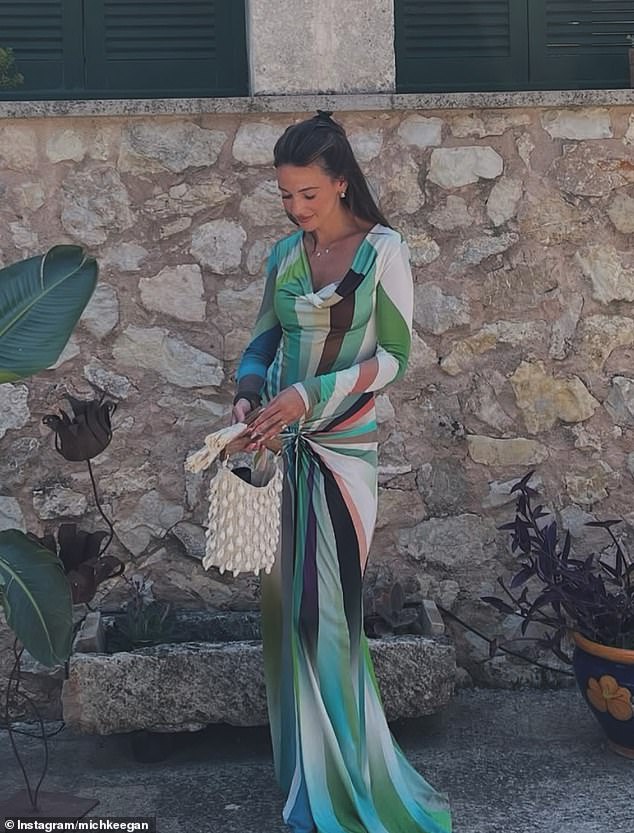 Michelle told fans her 'hoarding era is over' as she revealed some of her designer items up for grabs - including this stunning gown