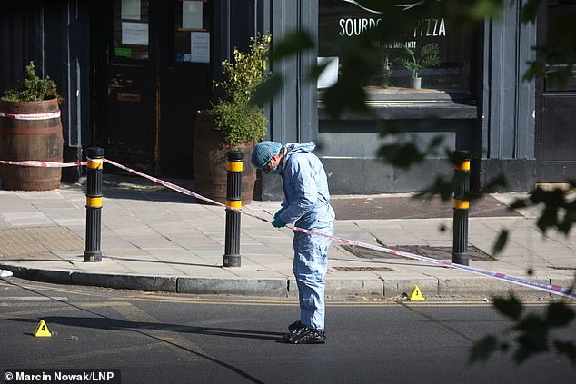 An investigator at the cordon outside Mamma Dough pizza restaurant on Coldharbour Lane