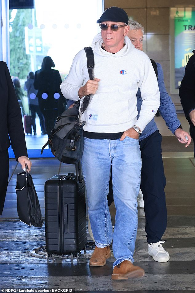 The actor, 58, who stars in the new movie alongside Cillian Murphy, 49, cut a casual figure while making his way through the arrival hall