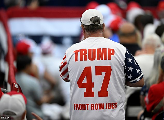 An attendee shows his support for Trump outside the event held in West Palm Beach on Friday