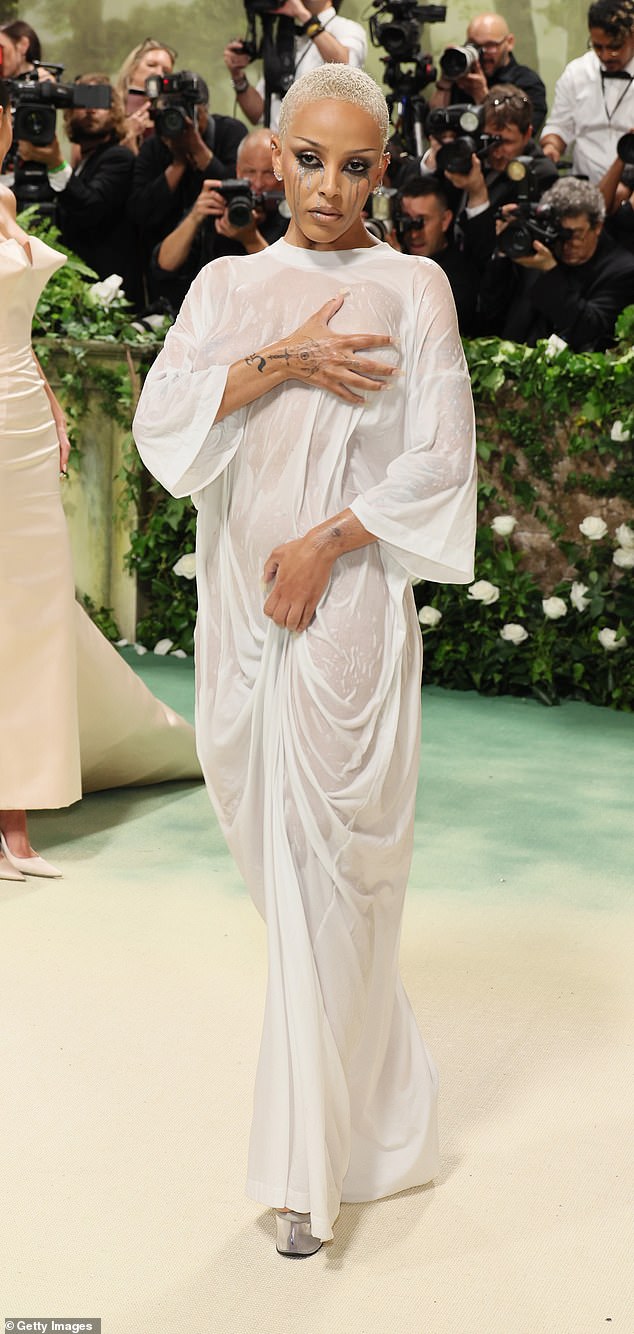 'Doja will lean fully surreal, wearing an avant-garde creation defined by exaggerated shapes and theatrical detailing,' she predicts (Pictured)