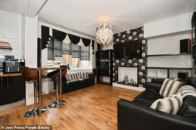 The property is arranged over three floors and the main living accommodation features a modern open-plan kitchen and lounge with a large bay window
