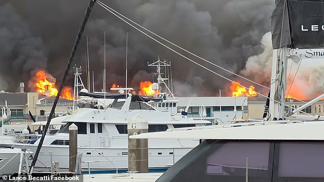 The fire broke out close to the marine with flames visible behind the boats