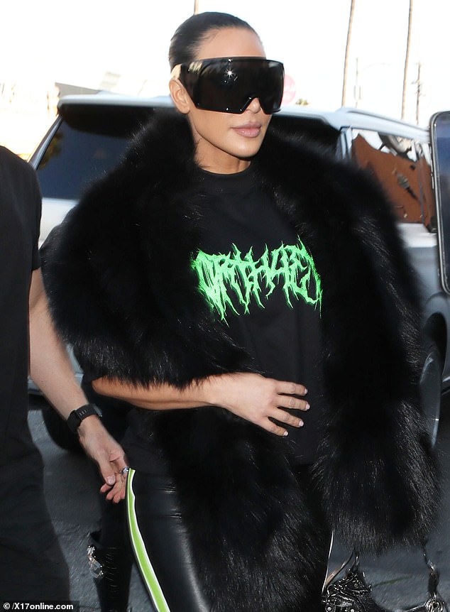 She also sported a black shirt that had her daughter's album name printed on the front and layered the look with a sleeveless, fuzzy black vest