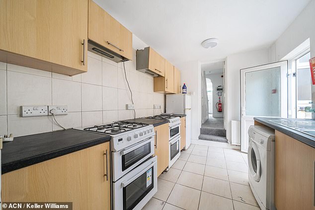 The home features eight bedrooms, two kitchens and three showers as well as a small garden out the back with off-road parking