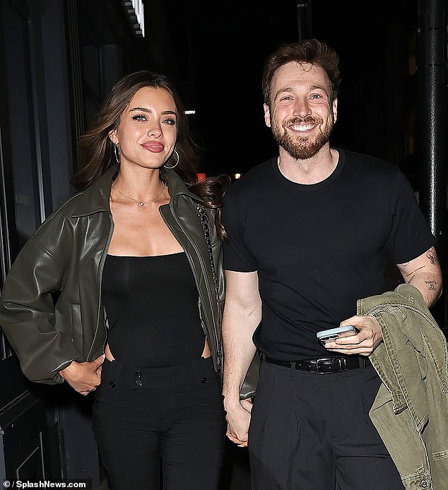 Sam held hands with his stunning girlfriend
