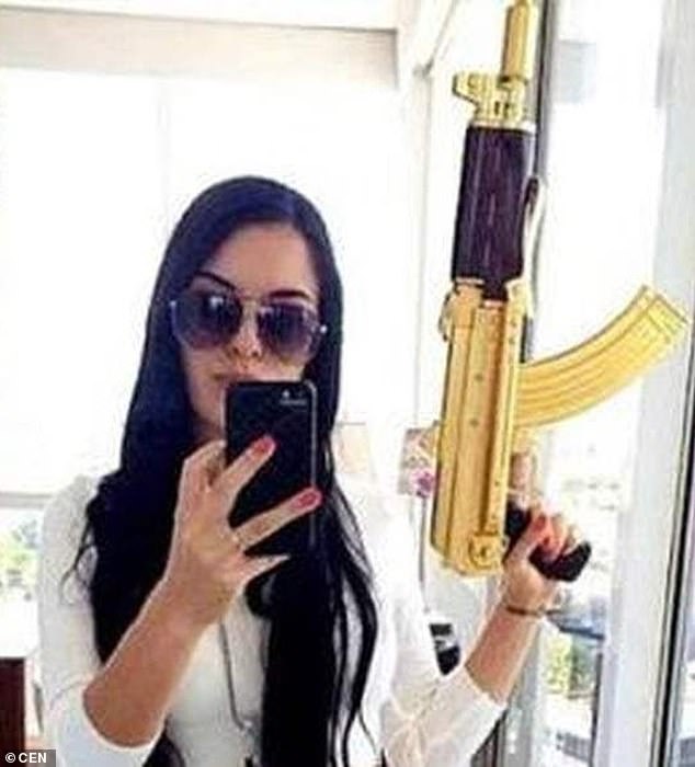 La Catrina posing with the gold-plated gun that became her trademark