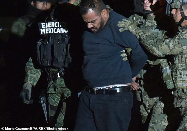 Mexican soldiers escort Orso 'El Cholo Ivan' Gastélum in Mexico City on January 9, 2016, a day after he and El Chapo were arrested