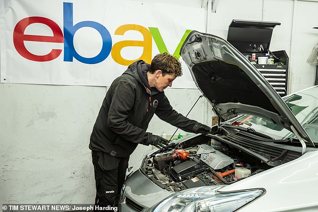 Laura Kennedy, founder of London's first all female garage Spanners with Manners, is pictured working on the Prius