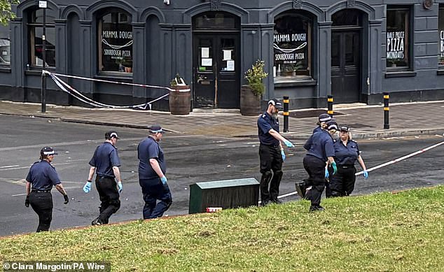 Police searching near the scene after four people were taken to hospital with gunshot wounds in Brixton