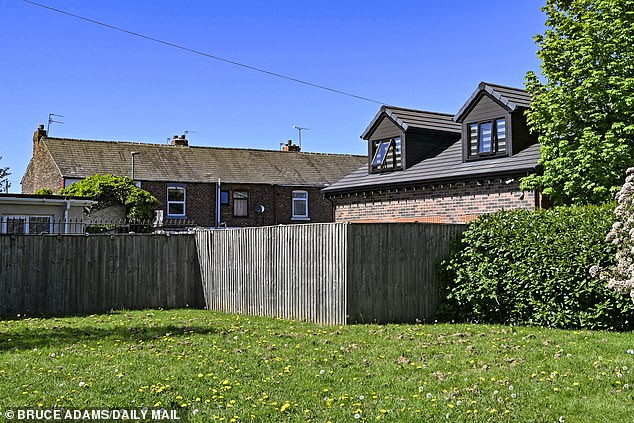 Pictured: A view of the annexe next to the neighbouring terraced homes