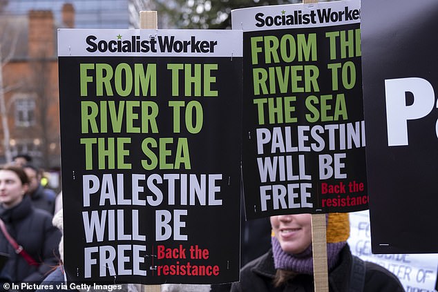 Protesters in Whitechapel calling for peace in Gaza in 2024, with placards reading the controversial 'from the river to the sea' message