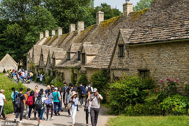Tourists visiting Arlington Row in Bibury. Only 700 people live in the village, but over a weekend up to 20,000 visit