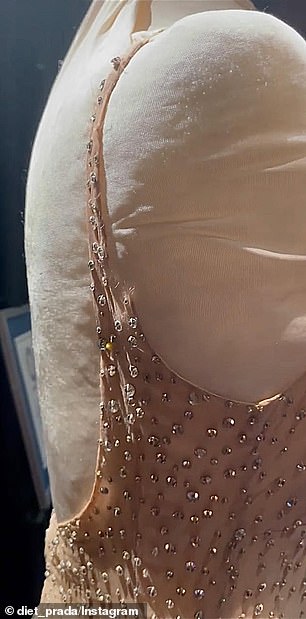 Images and video that were allegedly taken of the dress while it is on display at Ripley's Believe It or Not! show the 1962 gown with a visible tear at the back of the right strap (pictured)