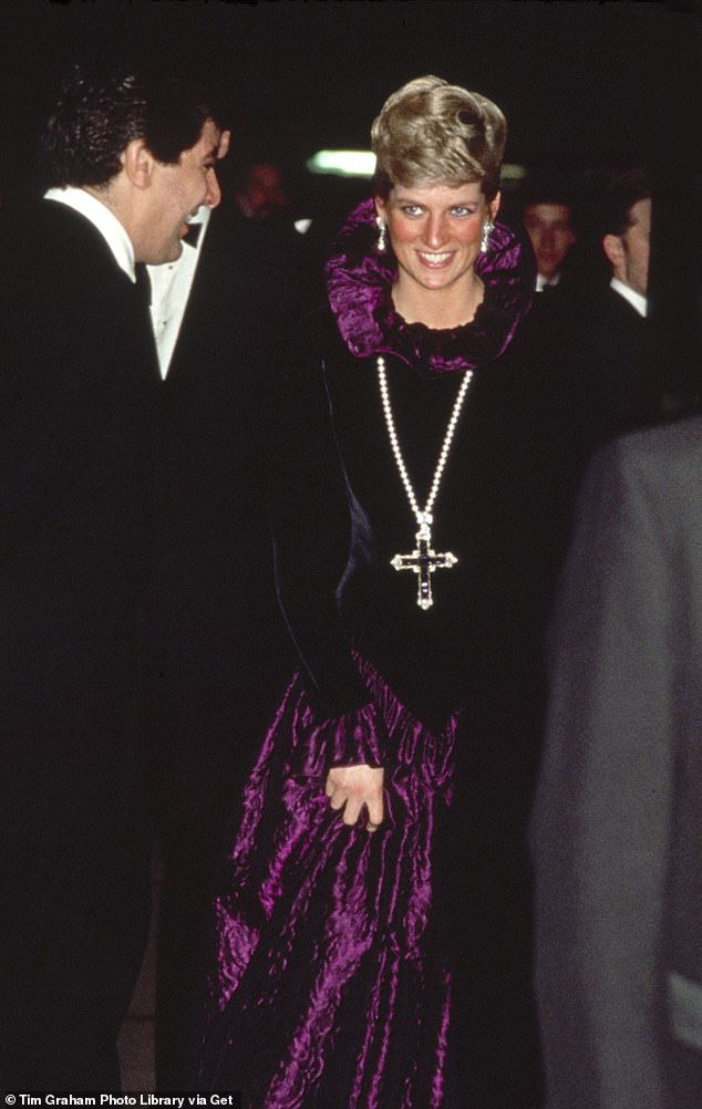 Diana, Princess Of Wales, is pictured wearing the pendant on a string of pearls when she attended the 1987 Birthright charity gala, where she donned a purple velvet Catherine Walker gown
