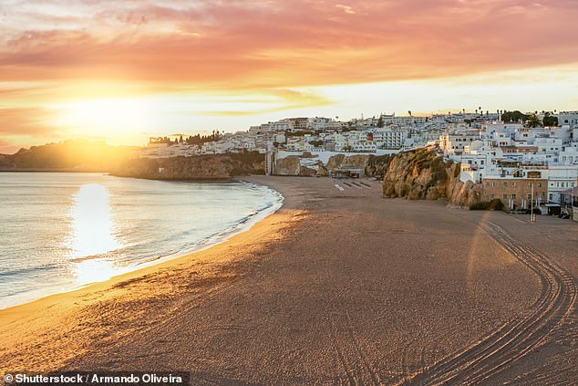 A panoramic view of Praia dos Pescadores in Albufeira at sunset in the Algarve
