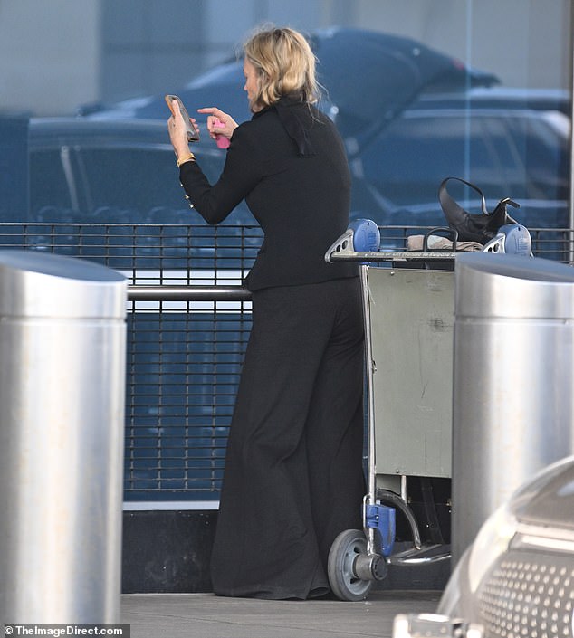 Kate was spotted checking her phone and vaping outside the arrivals terminal