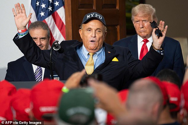 US President Donald Trump (R) listens as his personal lawyer Rudy Giuliani speaks to the City of New York Police Benevolent Association at the Trump National Golf Club in Bedminster, NJ, on August 14, 2020