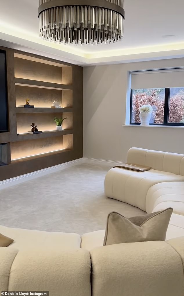 The living room featured a huge modular sofa and a media wall
