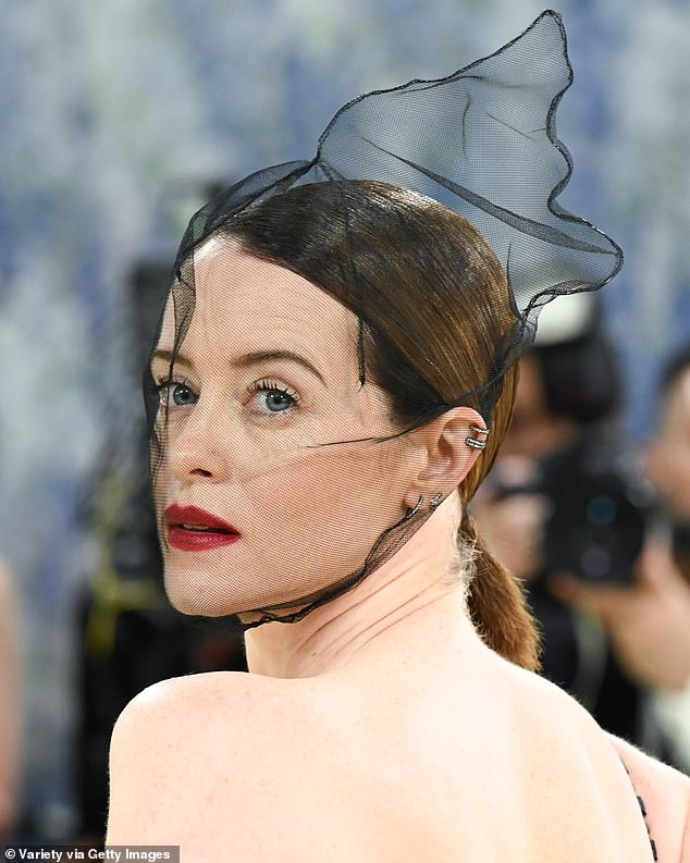 Drama was added with an opera coat and quirky veil which ensured all eyes were on her as she strolled the busy red carpet