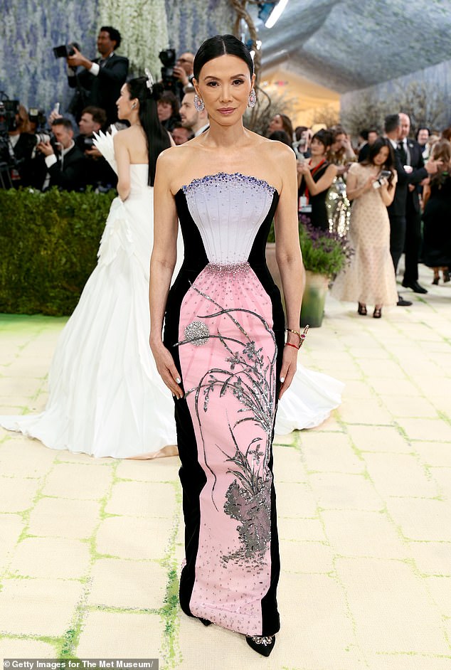 Wendi, 57, wore a strapless colour-blocked gown featuring a fan-shaped lavender panel at the corset which faded into a blush pink skirt