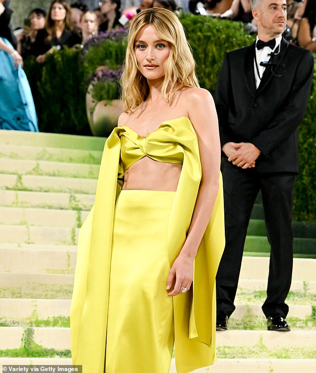 A matching high-waisted skirt clung to her figure and she allowed her blonde locks to cascade past her shoulders in light waves