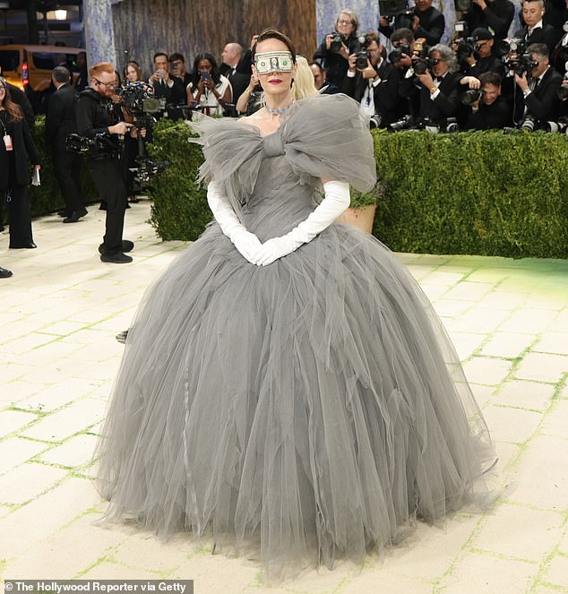 Along with her mask, Paulson accessorized her outfit with white arm-length gloves and a glitzy diamond choker necklace