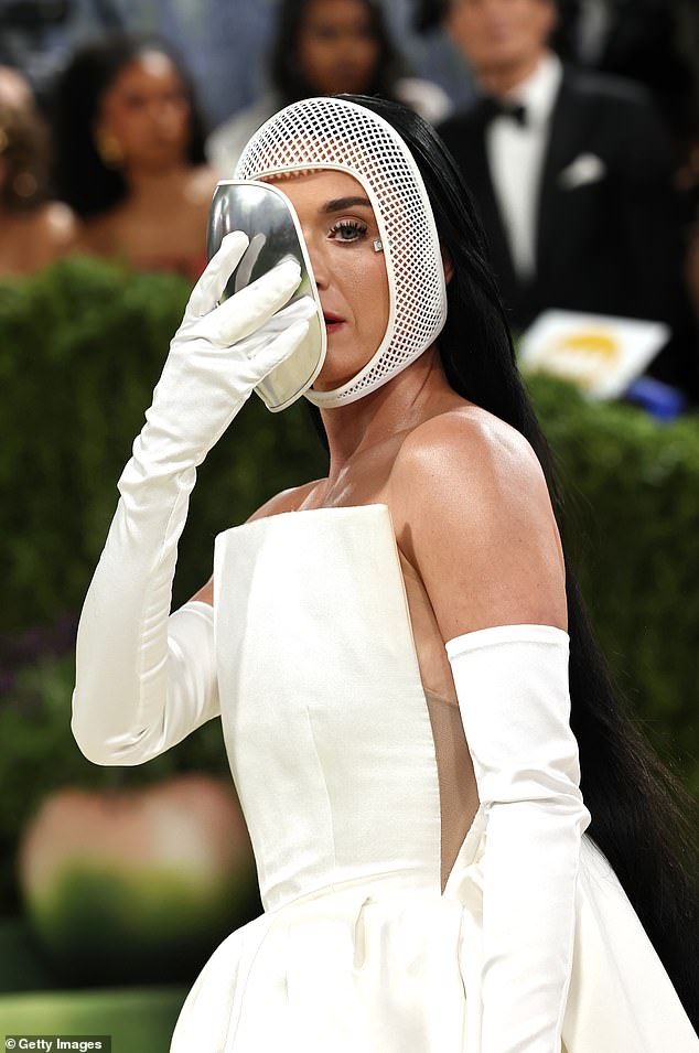 The singer also wore a matching white long strapless gown with trailing cape