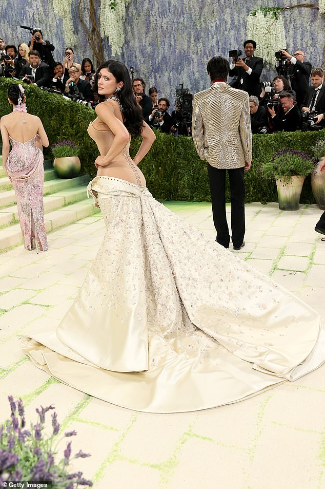 The dress also laced up the back, but it was left undone and bunched up at Jenner's hips, as if she had struggled to fit into it and had simply given up halfway through