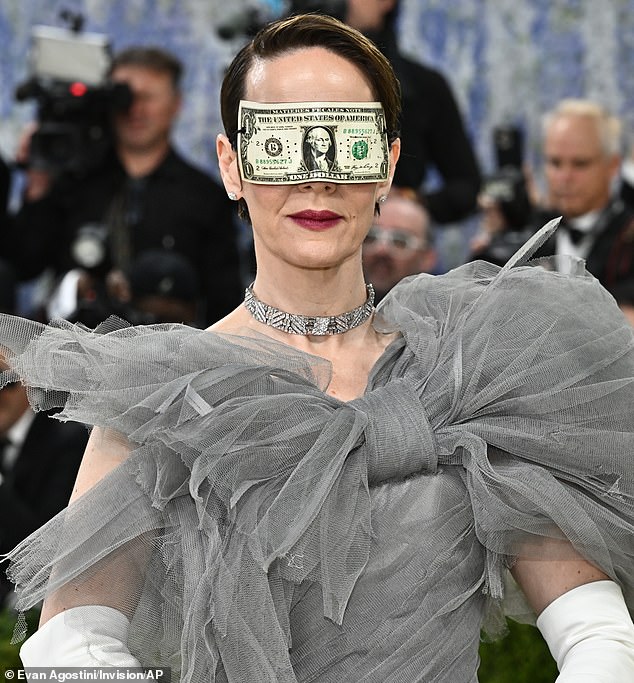 Sarah Paulson wore a dramatic, gray tulle dress with a dramatic bow at the neckline. She accessorized with a dollar bill around her eyes, apparently suggesting that we are blinded by money