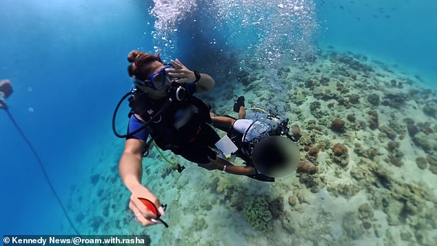 But when the two went underwater, she said the man started holding her hand as she recorded their dive on her camera