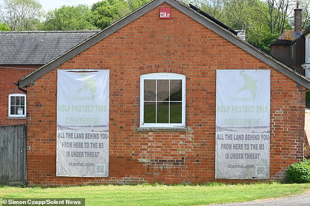 Pictured: Signs protesting against the proposed plans for the homes