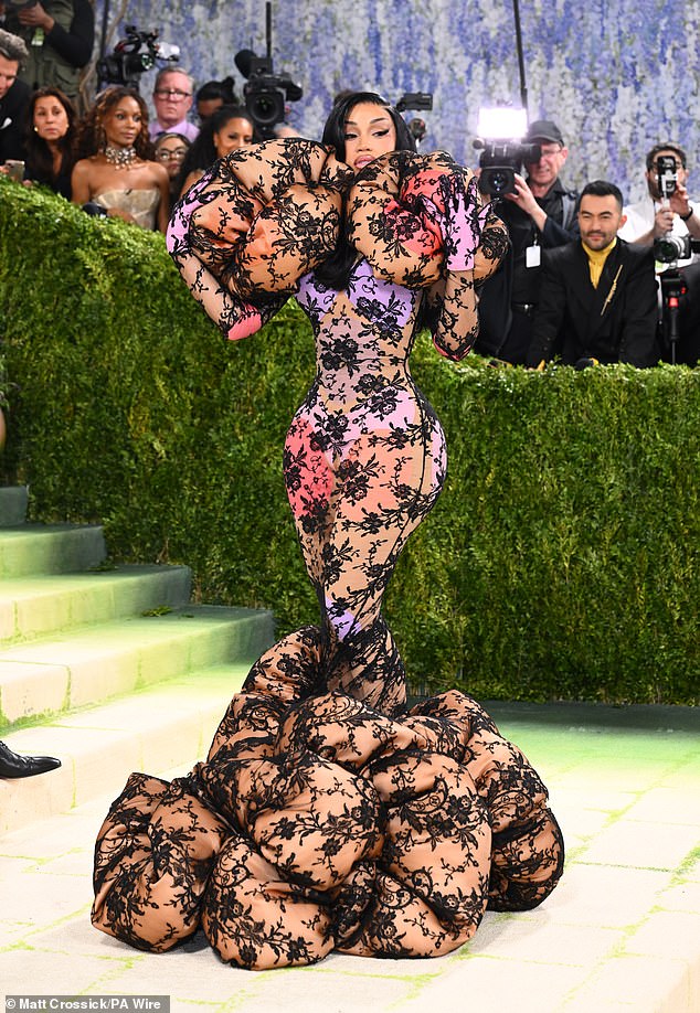 Cardi B was ripped on social media over her bizarre Marc Jacobs gown. The rapper told reporters that her giant sheer Marc Jacobs dress was inspired by The Doll by Hans Bellmer