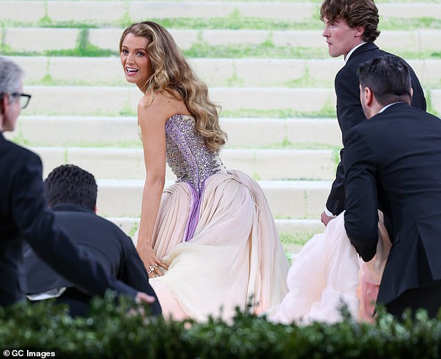 She seems to instruct him to pull the skirt away from her and to let it drag on the floor, as he steps back and places the fabric back down after the tense encounter