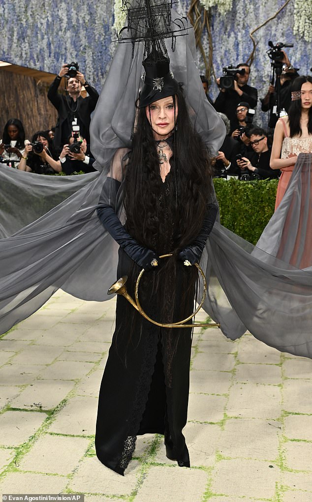 Madonna wore a gothic-inspired Saint Laurent lace gown and satin opera gloves