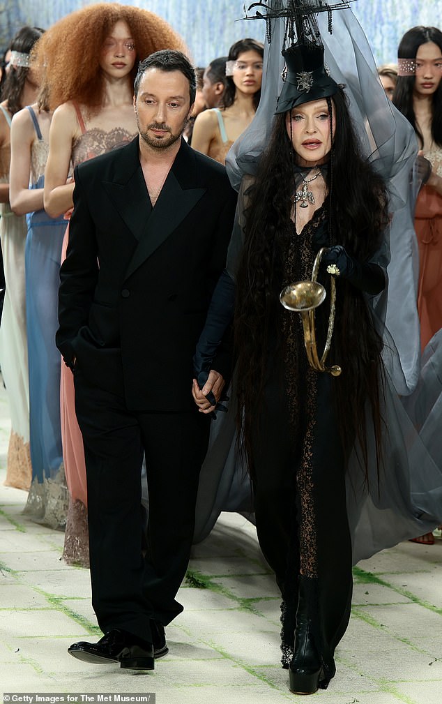 The extravagant ensemble was designed by Anthony Vaccarello, who posed with her during some moments