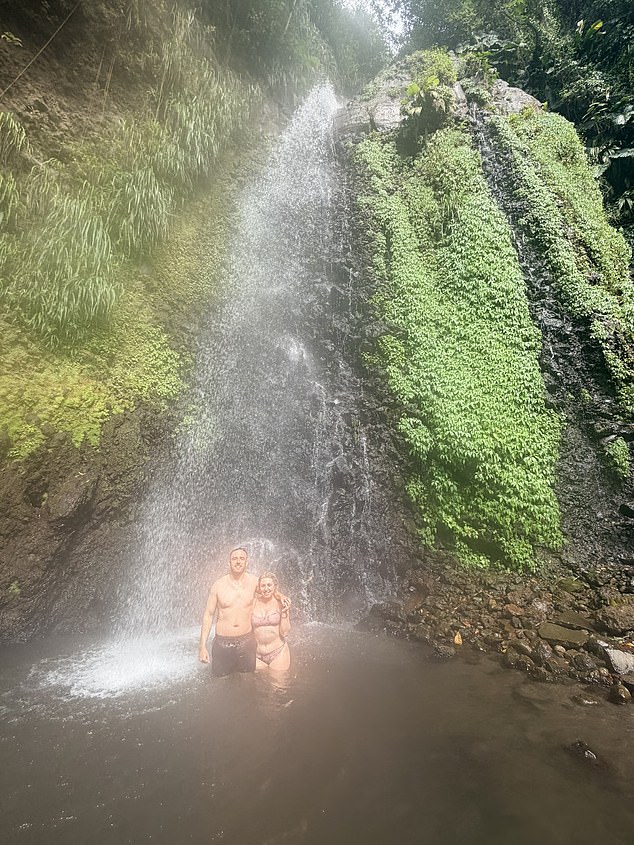 The couple at Saint Vincent's showstopping Dark View Falls, with roaring plumes of water behind them