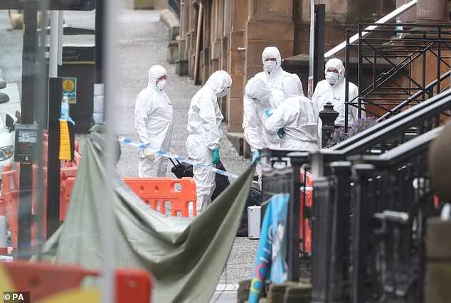 Forensic officers investigating the scene where Badreddin Abdalla Adam Bosh was shot