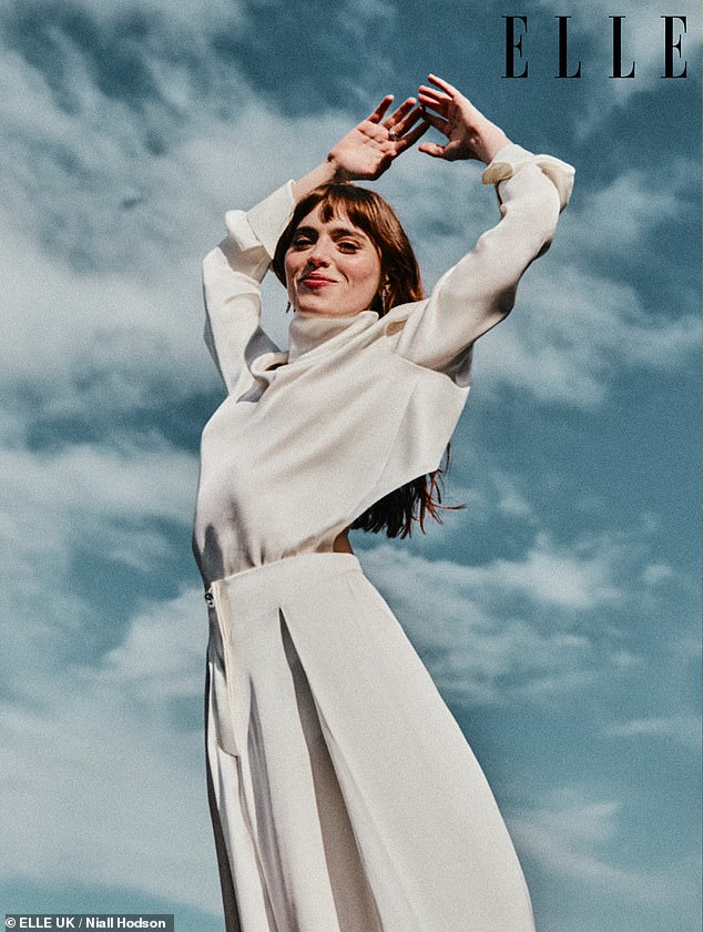 Flaunting her svelte frame in one figure-hugging negligee-inspired dress, she also posed up a storm in a draped backless blouse, raising her arms in the air and beaming against a blue sky backdrop
