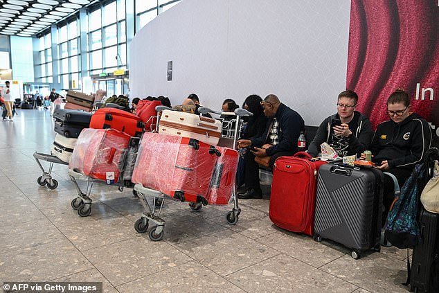 Passengers sit at London Heathrow waiting for news about flights when the conflict in the Middle East first began