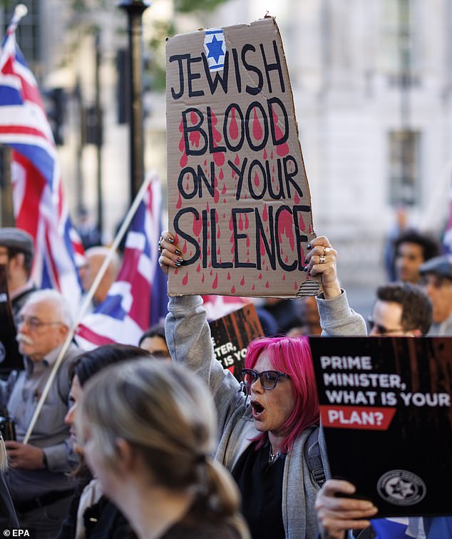 News of the incident comes as the Met Police revealed anti-Semitic hate crimes in London are the highest they have been in two years. Pictured: Protesters hold up placards and flags during a protest organised by the Campaign Against Antisemitism outside Downing Street last week
