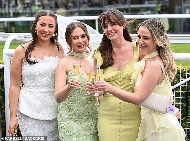 Cheers to Chester! Racegoers raise a glass to the event as they showcase their ensembles