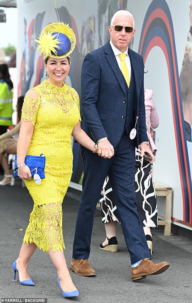 Couple goals: A pair at the races show off their coordinating look as they arrive at the event