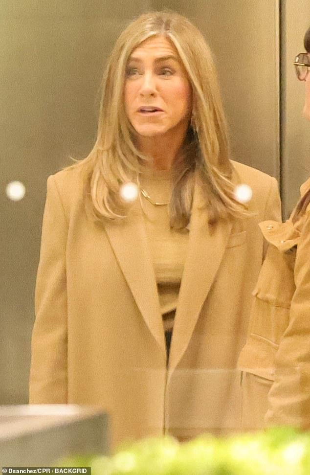 The 56-year-old actress wore a tan-colored coat and sweater while shooting in downtown Los Angeles